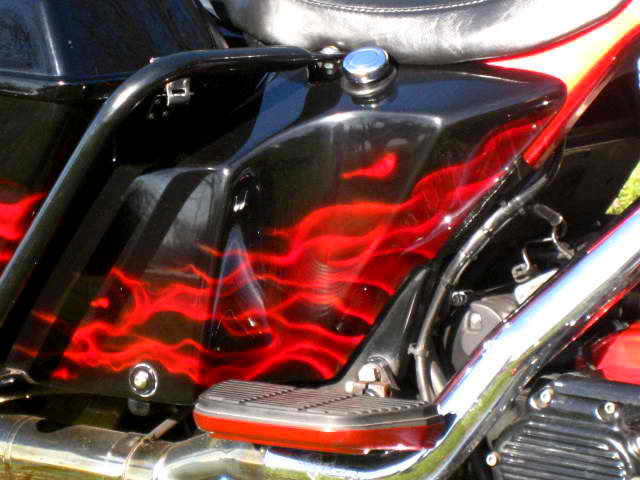 Motorcycle with red realistic flames airrbushed custom paint job by Chuck Sawyer